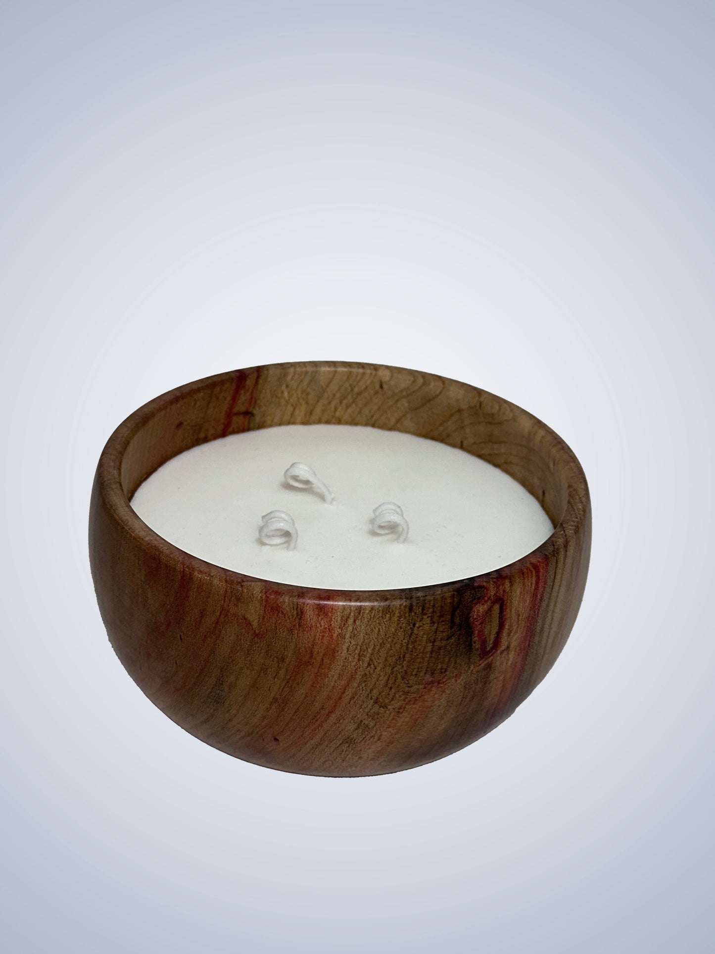 Candle in a noble wood bowl